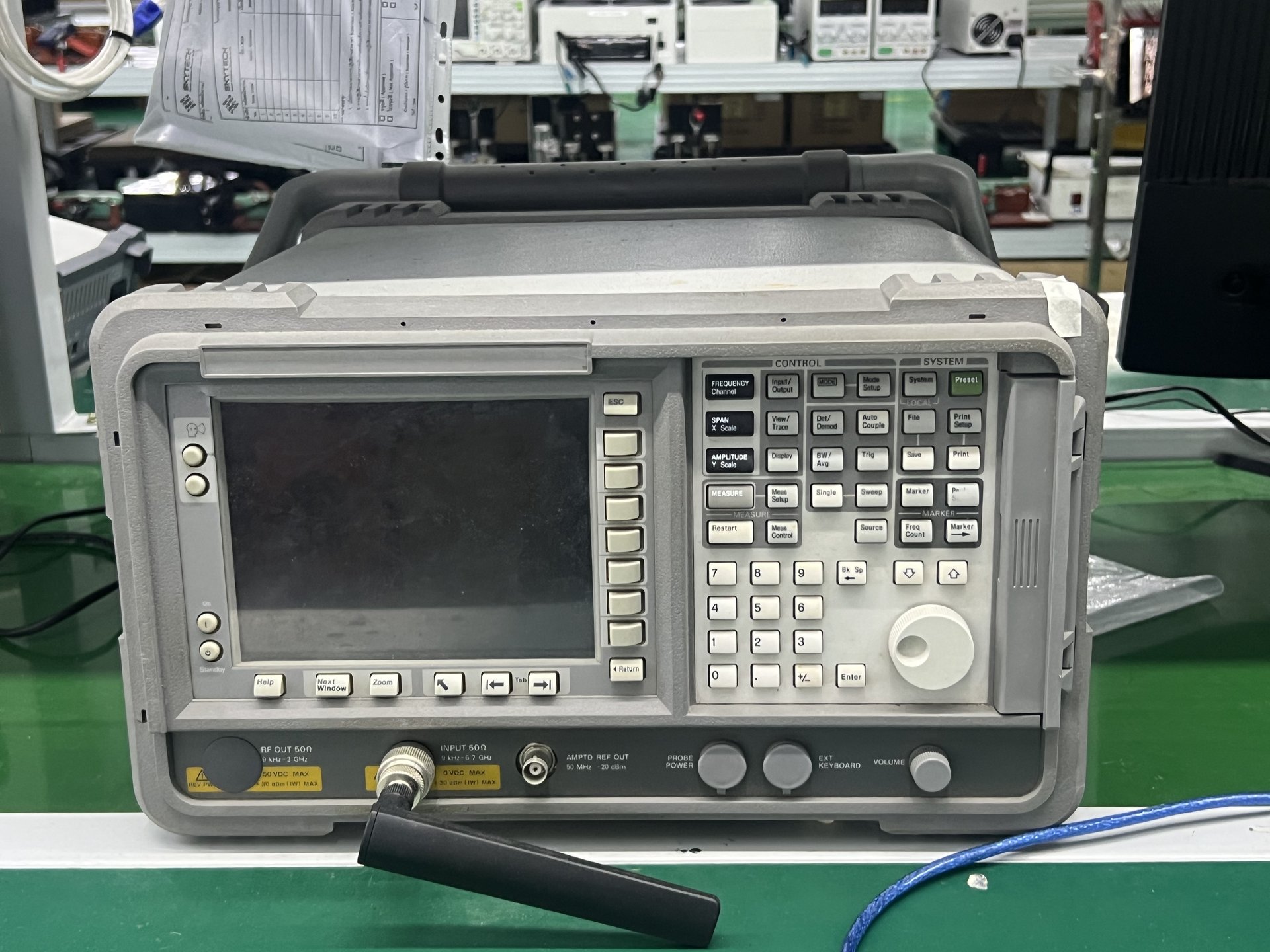 Agilent N9342C handheld spectrum analyzer 9 kHz - 3 GHz with antenna on engineering bench