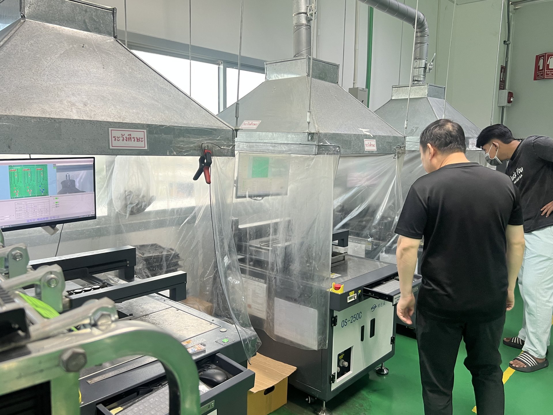 JUKI QS-250C selective wave soldering machine with brand logo and engineers