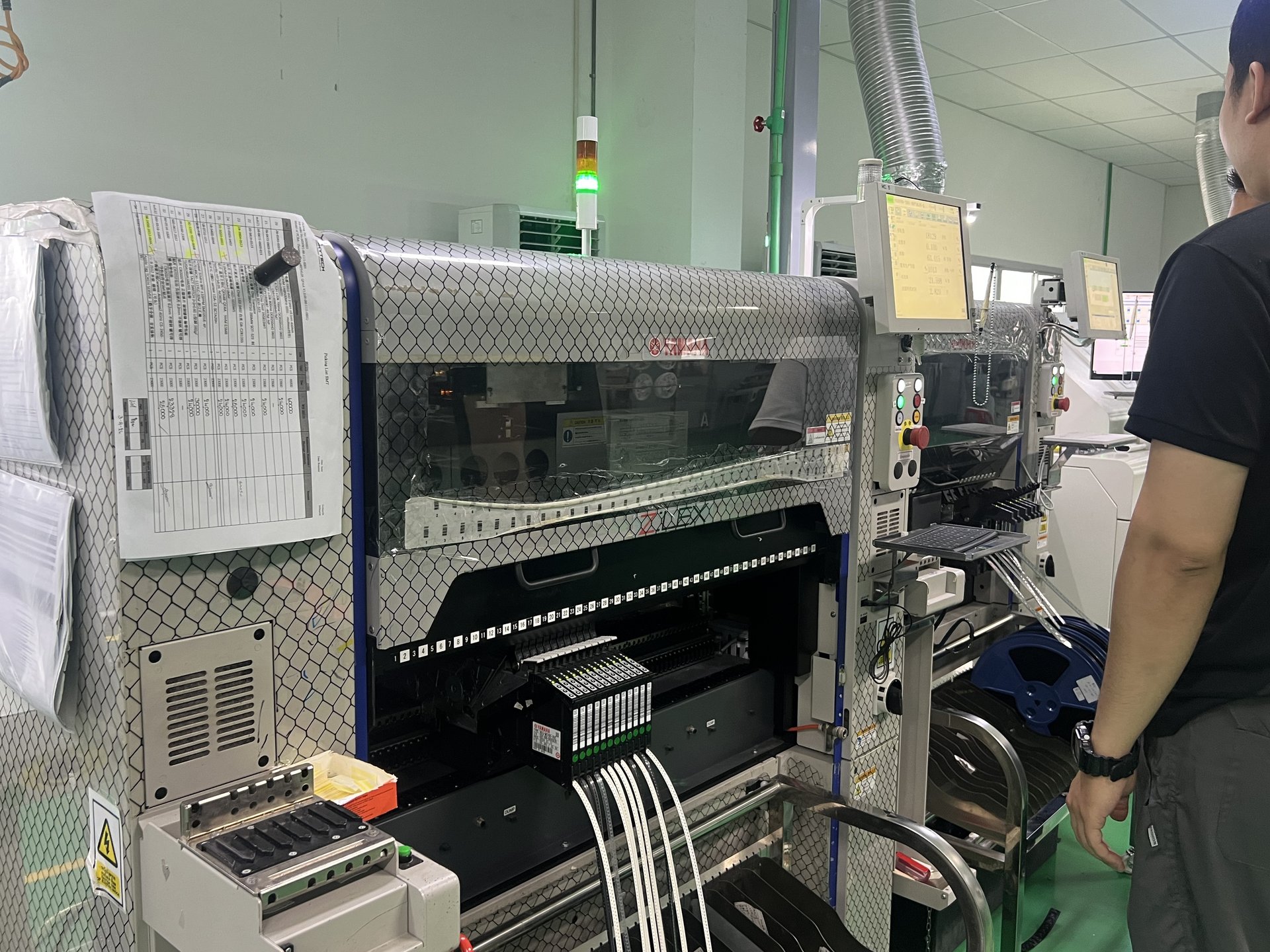 Yamaha YSM20 SMT pick-and-place machine with reel feeder and operator